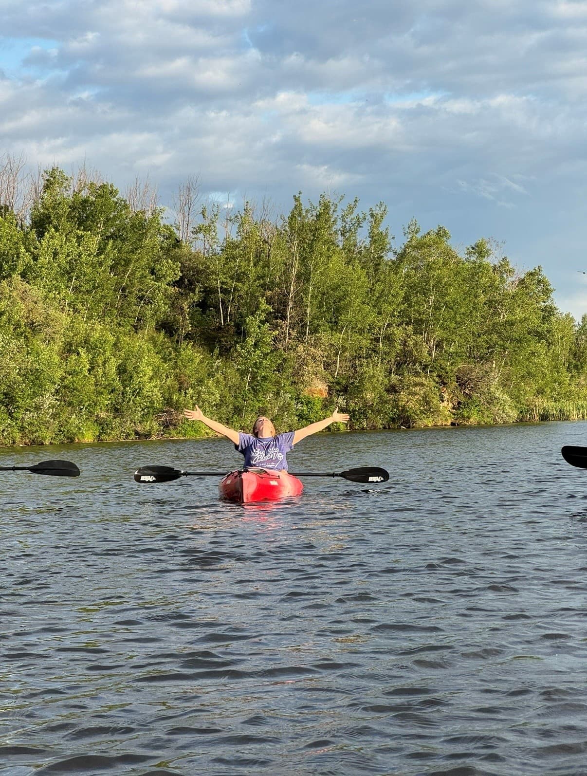 Kayaking on Castor creek with arms outstretched